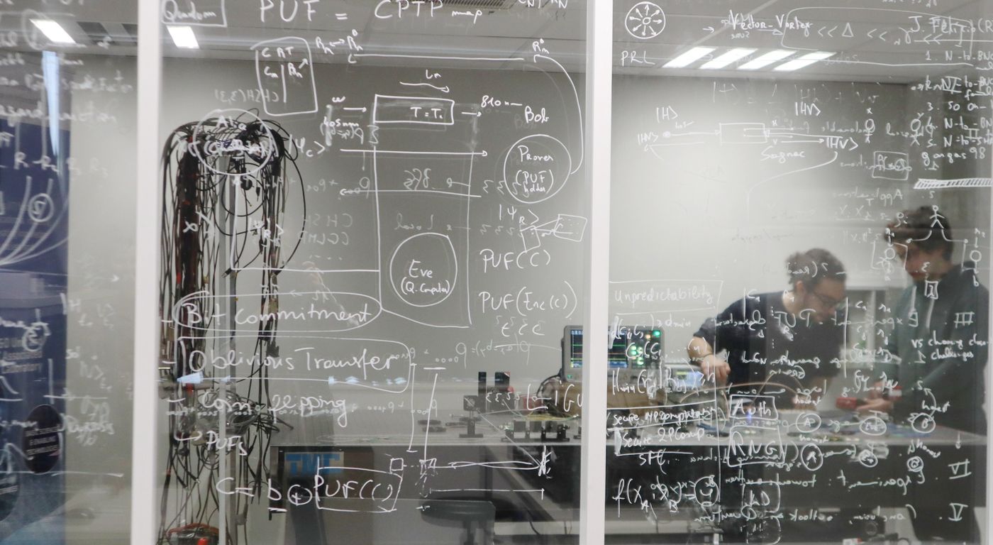 QIQO researchers working in a quantum optics laboratory
